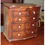 A miniature bow fronted chest of drawers