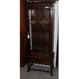 A carved oak glazed display cabinet