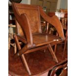 A Victorian oak Glastonbury style armchair labelled Howard's Patented Paroueterie number 1548