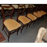 A set six of Victorian walnut balloon back chairs