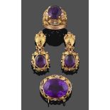 An Amethyst Ring, the round cut amethyst in a yellow claw setting, within a tri-colour foliate