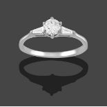 A Platinum Diamond Solitaire Ring, the round brilliant cut diamond in a claw setting, to tapered