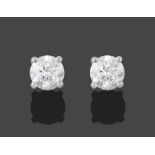 A Pair of 18 Carat White Gold Diamond Solitaire Earrings, the round brilliant cut diamonds in four