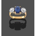 A Diamond and Blue Paste Three Stone Ring, the emerald-cut blue paste in yellow claw settings,