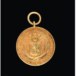 A Victorian Gold Medal, Stamped '15ct', Dated 1897, circular the obverse with a shield chased with