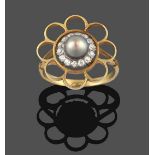 A Cultured Pearl and Diamond Cluster Ring, stylised in the form of a flower, the cultured pearl