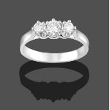 A Platinum Diamond Three Stone Ring, the graduated round brilliant cut diamonds in claw settings, to