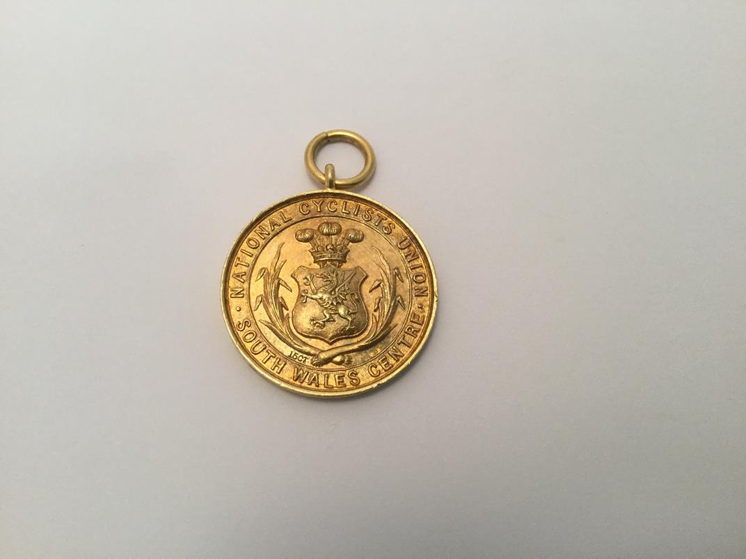 A Victorian Gold Medal, Stamped '15ct', Dated 1897, circular the obverse with a shield chased with - Image 2 of 3