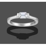 A Platinum Diamond Solitaire Ring, the emerald-cut diamond in a broad two claw setting, to a plain