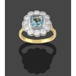 An Aquamarine and Diamond Cluster Ring, the cushion cut aquamarine within a border of round