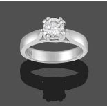 A Diamond Solitaire Ring, the round brilliant cut diamond in a white claw setting, to a tapered