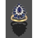 A Sapphire and Diamond Cluster Ring, the pear cut sapphire within a border of eight-cut diamonds, to
