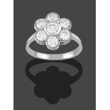 A Diamond Cluster Ring, the round brilliant cut diamond within a border of smaller round brilliant