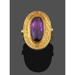 An Amethyst Ring, the oval cut amethyst in a yellow rubbed over setting extending to a textured