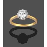 A Diamond Solitaire Ring, the round brilliant cut diamond in a white claw setting, to a yellow