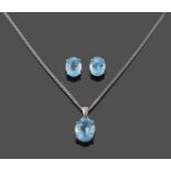 A 9 Carat White Gold Blue Topaz Pendant on A 9 Carat White Gold Chain, the oval mixed cut blue topaz