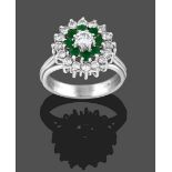 An 18 Carat White Gold Emerald and Diamond Cluster Ring, the central round brilliant cut diamond