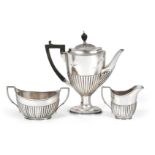 A Three-Piece Edward VII Silver Coffee-Service, by William Hutton and Sons, London, 1904 and 1908,