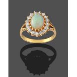 An Opal and Diamond Cluster Ring, the oval opal cabochon within a border of old cut diamonds in