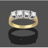 A Diamond Four Stone Ring, the round brilliant cut diamonds in white claw settings, to a yellow