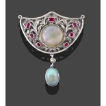 An Arts & Crafts Style Opal and Ruby Brooch, the shield motif set centrally with a circular cabochon