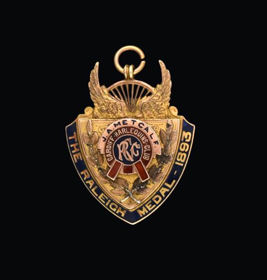 A Victorian Gold and Enamel Medal, by Vaughton and Sons, Birmingham, 1893, 9ct, shield shaped, the