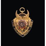 A Victorian Gold and Enamel Medal, by Vaughton and Sons, Birmingham, 1893, 9ct, shield shaped, the