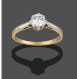 A Diamond Solitaire Ring, the round brilliant cut diamond in a white claw setting, to a yellow