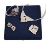 A Silver Sapphire Necklace, Bangle, Brooch/Pendant and Earring Suite, of openwork matted abstract