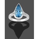 An Aquamarine and Diamond Ring, a pear cut aquamarine in a white semi-rubbed over setting to