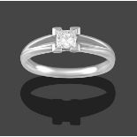 A Platinum Diamond Solitaire Ring, the princess cut diamond in a four claw setting, to V-shaped