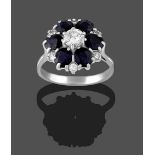 A Sapphire and Diamond Cluster Ring, the round brilliant cut diamond within a border of round cut