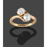 An 18 Carat Gold Diamond Two Stone Twist Ring, the two old cut diamonds in yellow claw settings,