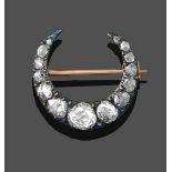 A Diamond Crescent Brooch, set throughout with rose cut diamonds in claw and collet settings,