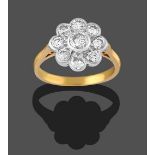 An 18 Carat Gold Diamond Cluster Ring, the central round brilliant cut diamond within a border of