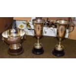 Two twin handled silver plated trophy cups, and a silver plated trophy bowl with ring and lion