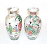 A pair of 20th century Chinese baluster vases with famille rose decoration of figures in a garden,