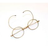 A pair of glasses, stamped '10CT'