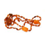 An amber bead necklace, drop length 14cm, necklace length 90cm . Gross weight 59.8 grams.