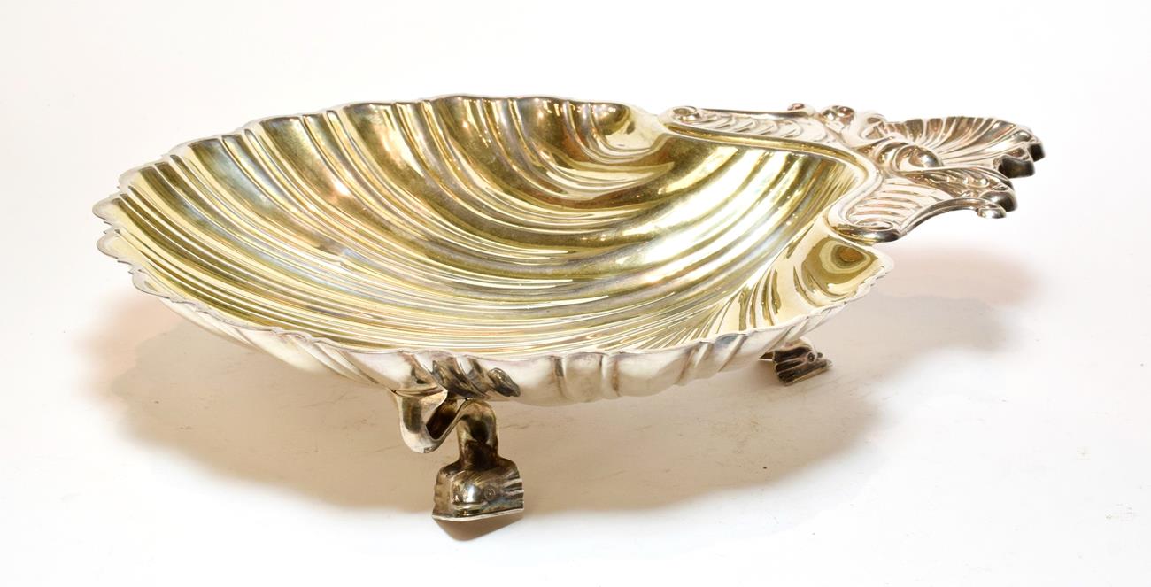 An Italian silver shell shaped dish, 800 standard, 20th century, on three stylised dolphin feet