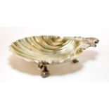 An Italian silver shell shaped dish, 800 standard, 20th century, on three stylised dolphin feet