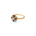 An 18 carat gold sapphire and diamond cluster ring, finger size L1/2. Gross weight 4.0 grams.