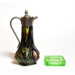 A small Loetz style glass jug with plated mounts and a green glass ashtray