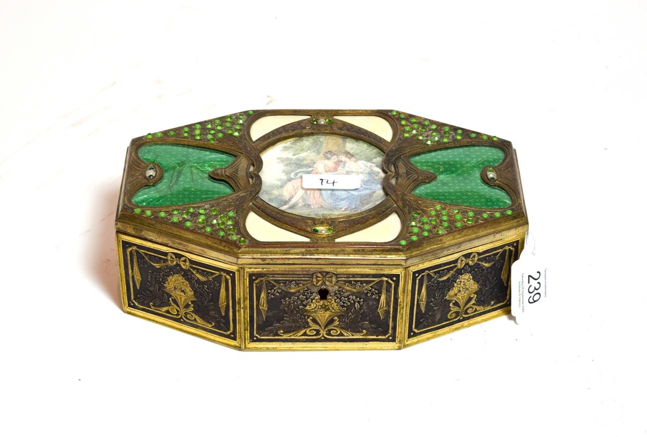 An Art Deco silvered and enamel box, oblong shape, chased with flower and foliage and set with green