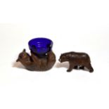 A Black Forest carved bear with another supporting a blue glass dish (2)