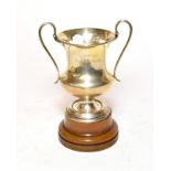 A George V silver trophy, London, 1923, baluster and on spreading foot with two scroll handles,