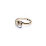 A diamond and cultured pearl crossover ring, stamped '18CT' and 'PT', finger size I . Gross weight