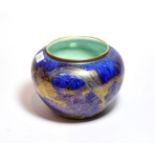 Daisy Makeig-Jones: A Wedgwood dragon lustre jardiniere with mottled blue ground, decorated with