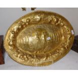 A gilt-metal charger, in the German late 17th century taste, shaped oval and with crimped rim, the