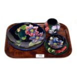 A Walter Moorcroft clematis footed bowl and three other pieces of Moorcroft pottery